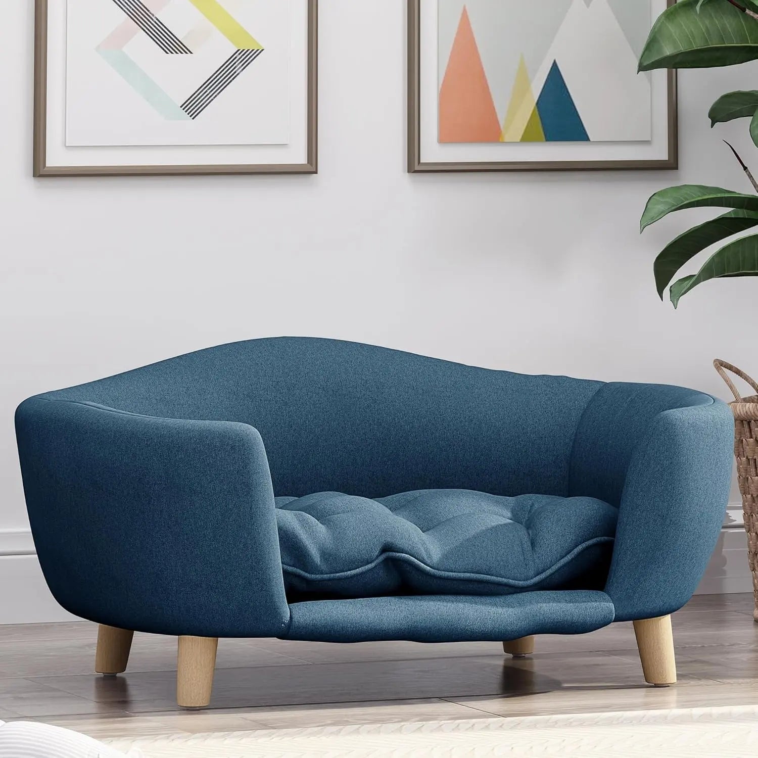 Blue corduroy sofa bed with rounded arms, tufted inner cushion, and wooden legs