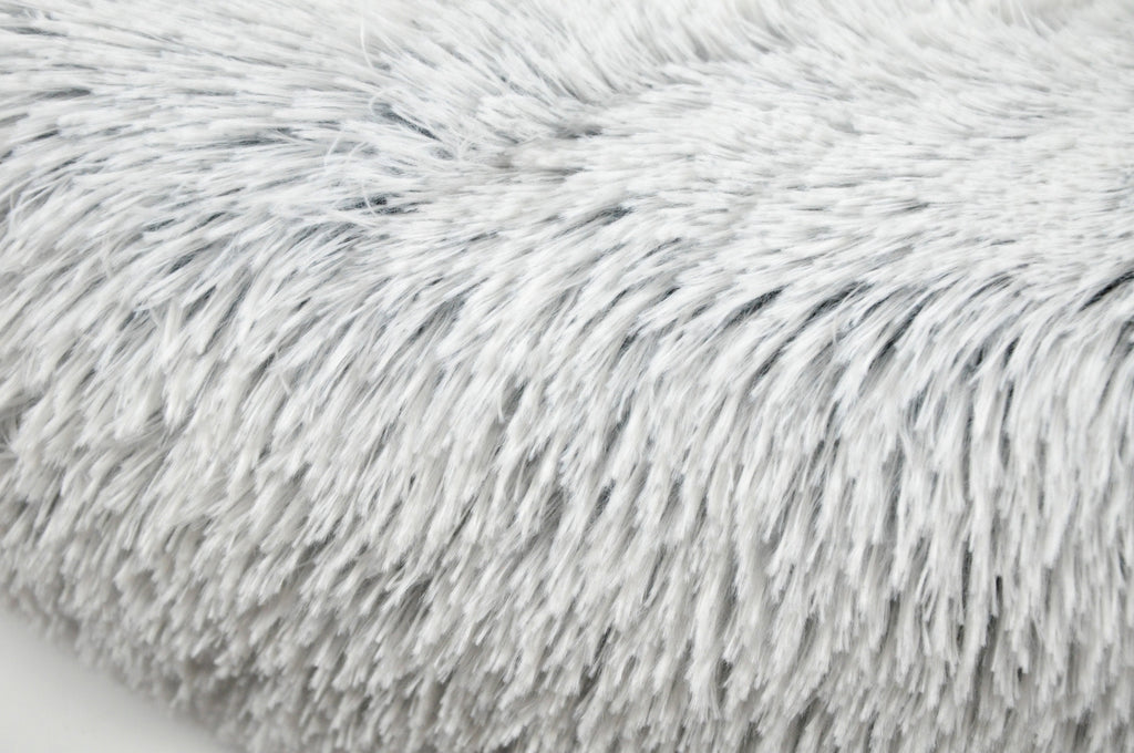 Light gray shag faux-fur pet bed surface with dense, long-pile texture