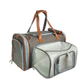 Gray mini pet carrier with expandable front mesh, brown handles and rolled accessory strap