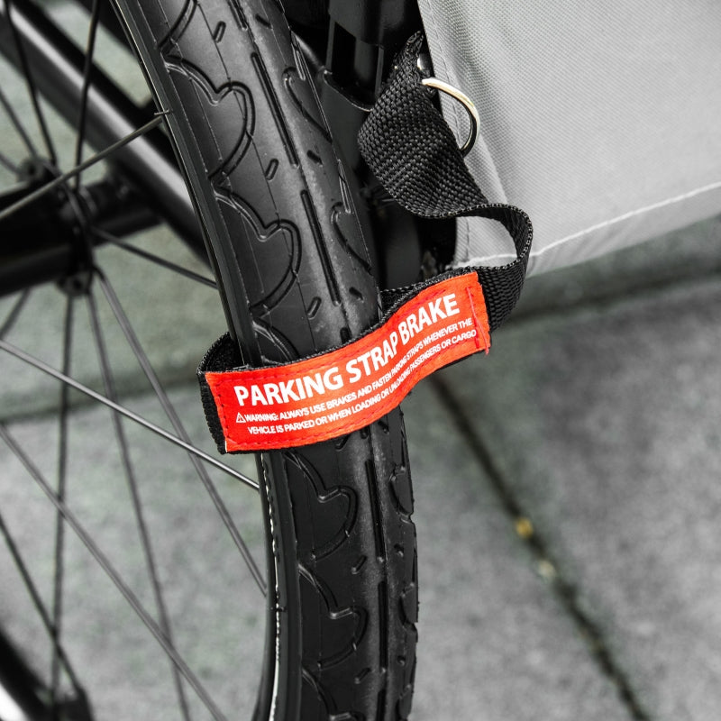 Pet trailer wheel parking strap with red warning label