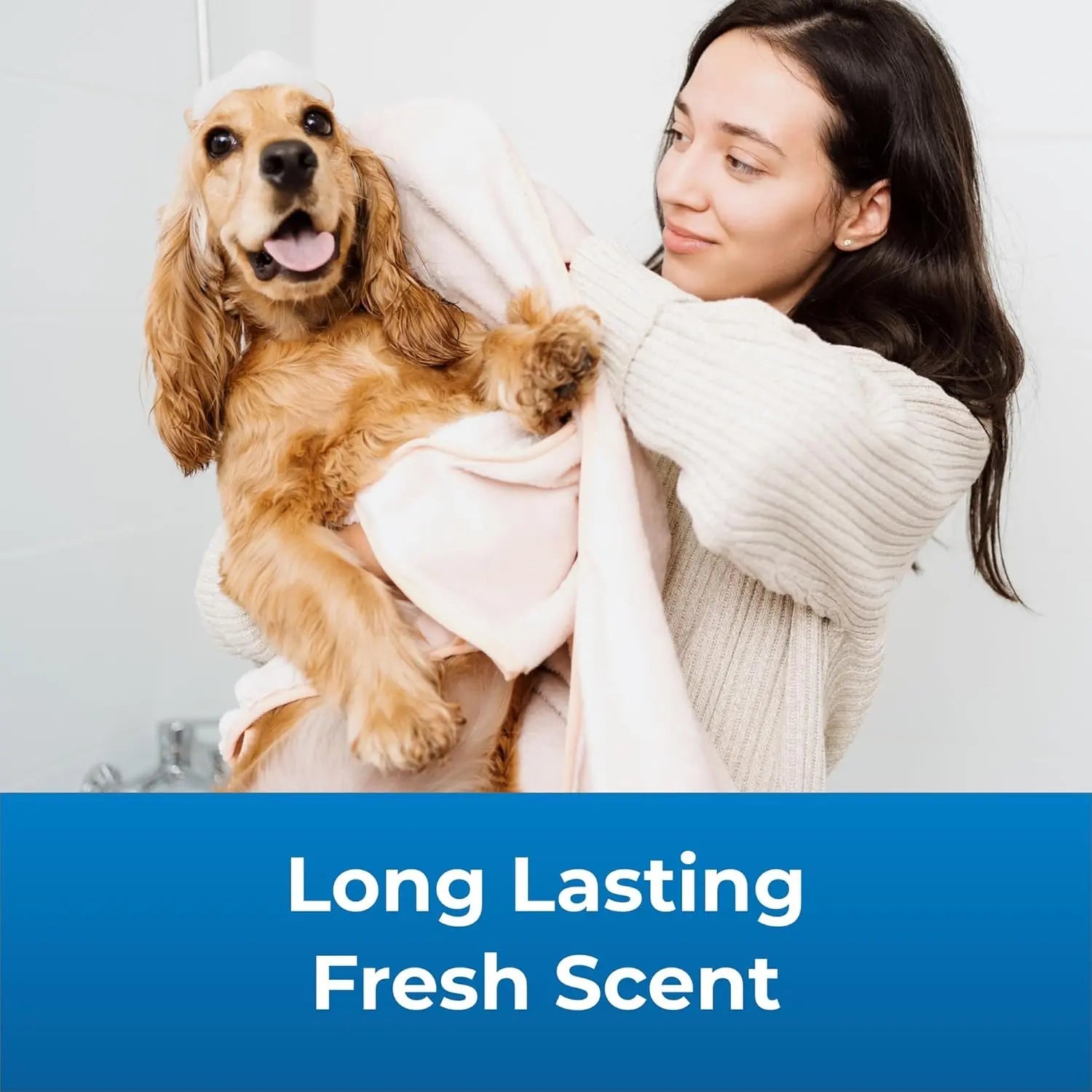 Dog shampoo and conditioner set, woman holding a tan dog wrapped in a towel