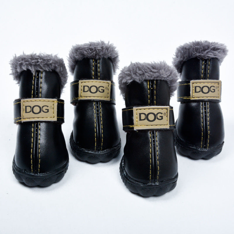 Black waterproof dog snow boots with gray fuzzy cuffs and tan “DOG” logo straps