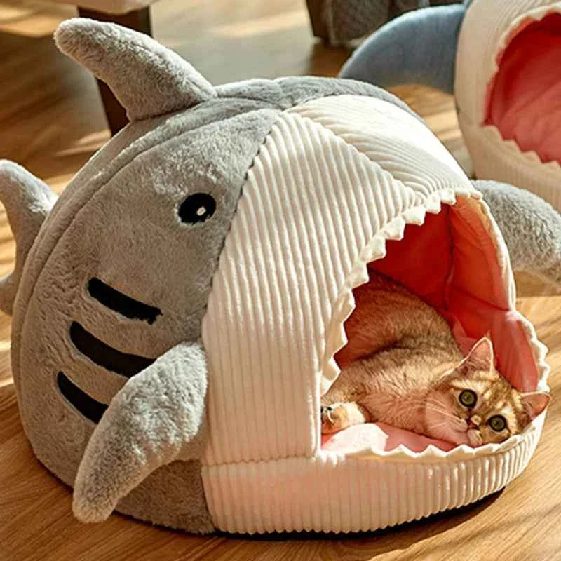 Grey shark cat bed cave with open entrance, ribbed white cushion, cat sleeping inside