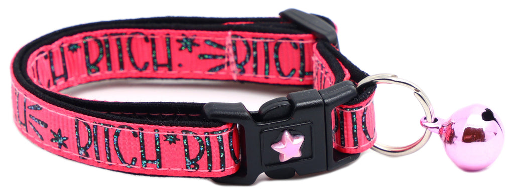 Pink fabric cat collar with black buckle, star emblem and pink bell