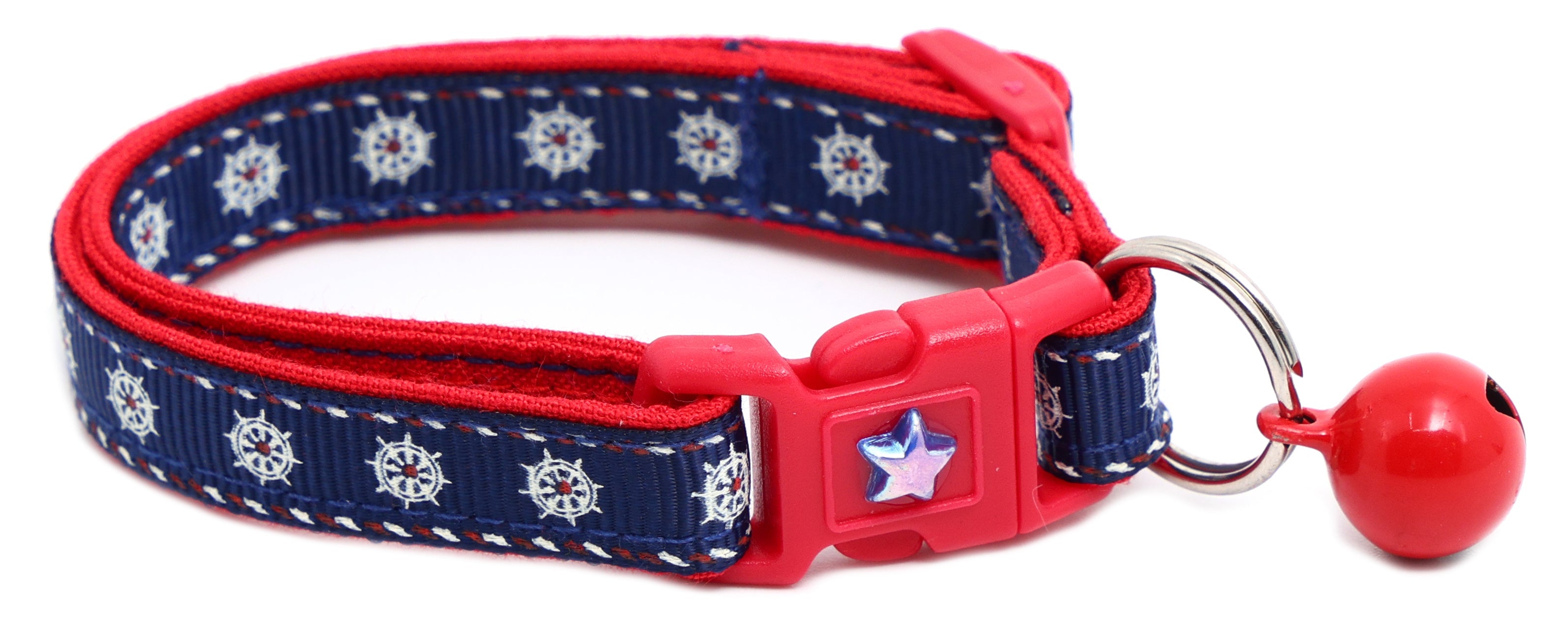 Red and navy cat collar with star charm, red ball bell, and breakaway buckle