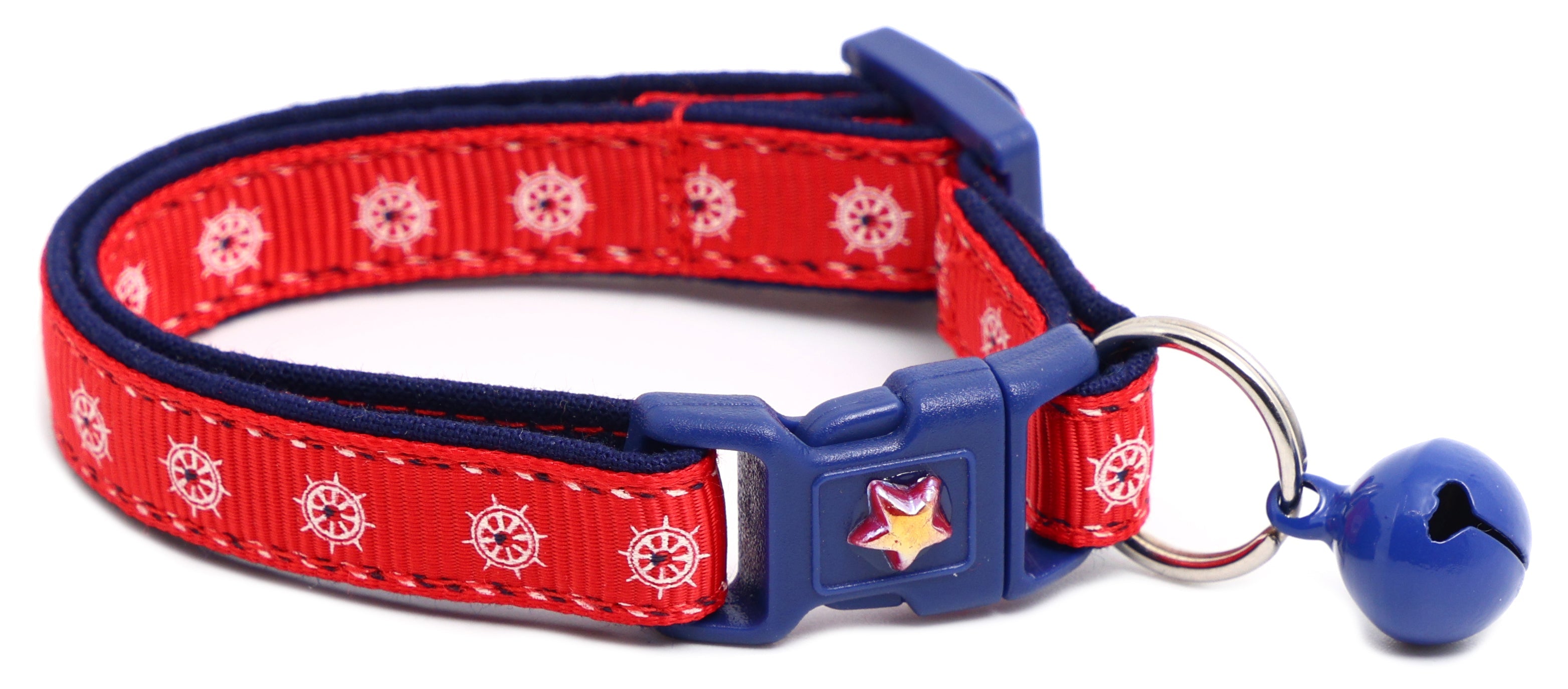 Red ships wheel breakaway cat collar with navy trim; blue breakaway buckle and bell.