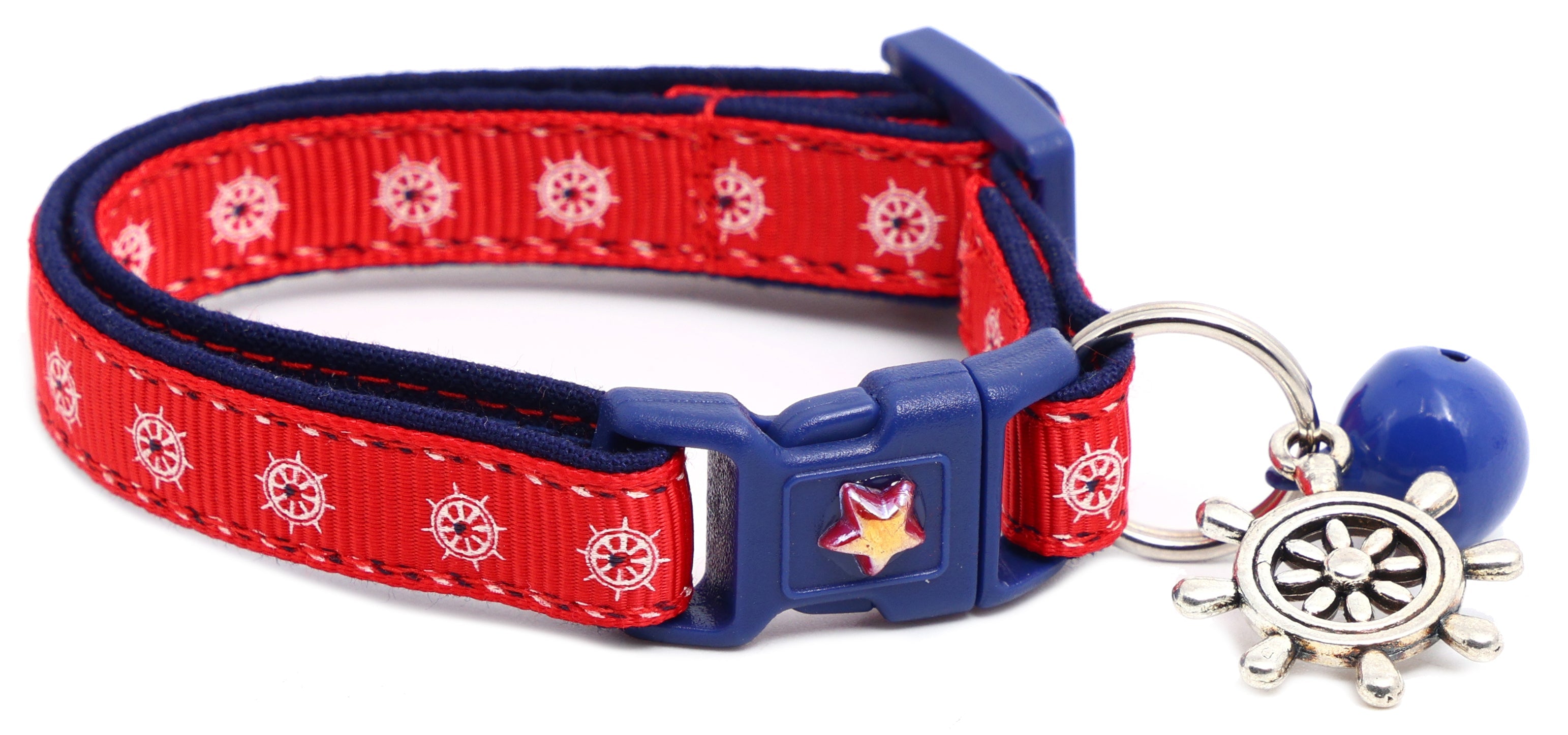 Red ships wheel breakaway cat collar with navy trim; ship wheel charm plus blue bell.
