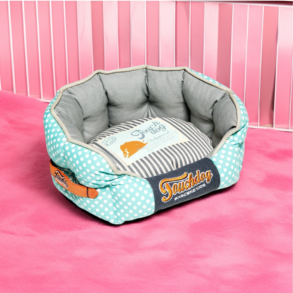 Rounded dog bed with teal polka-dot sides and gray padded cushion