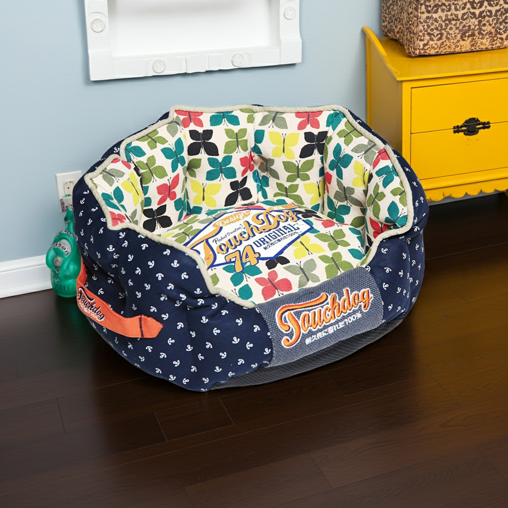 Round Touchdog designer dog bed with navy cover and colorful leaf bird print liner