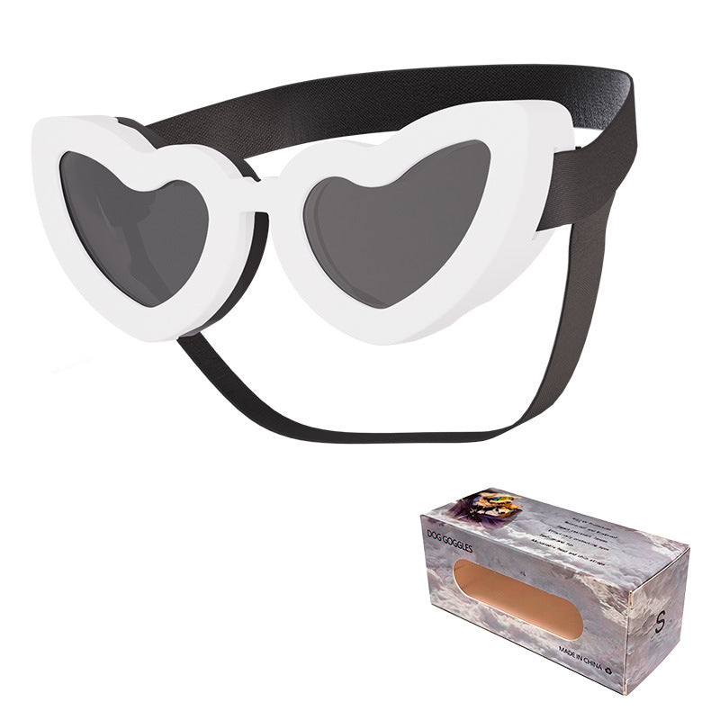 White heart-shaped pet sunglasses with black adjustable strap and dark lenses