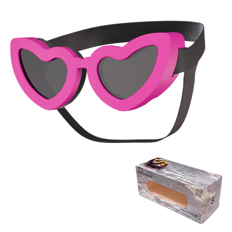 Hot pink heart-shaped pet sunglasses with black adjustable strap and dark lenses