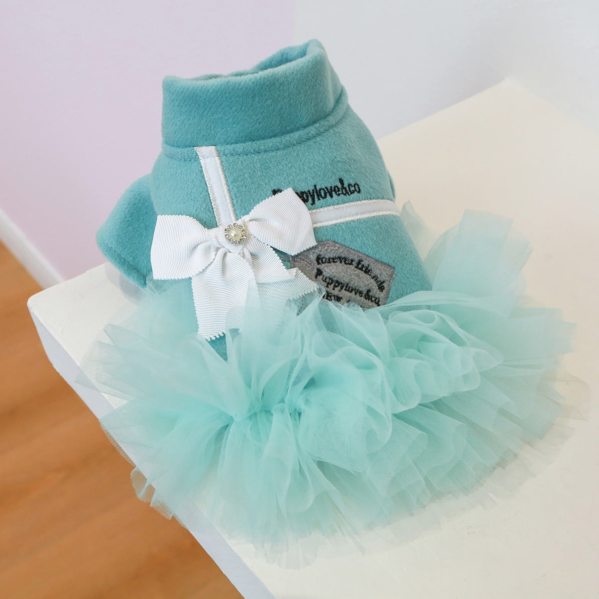 Back view of teal dog dress with mint tulle tutu skirt and white ribbon bow