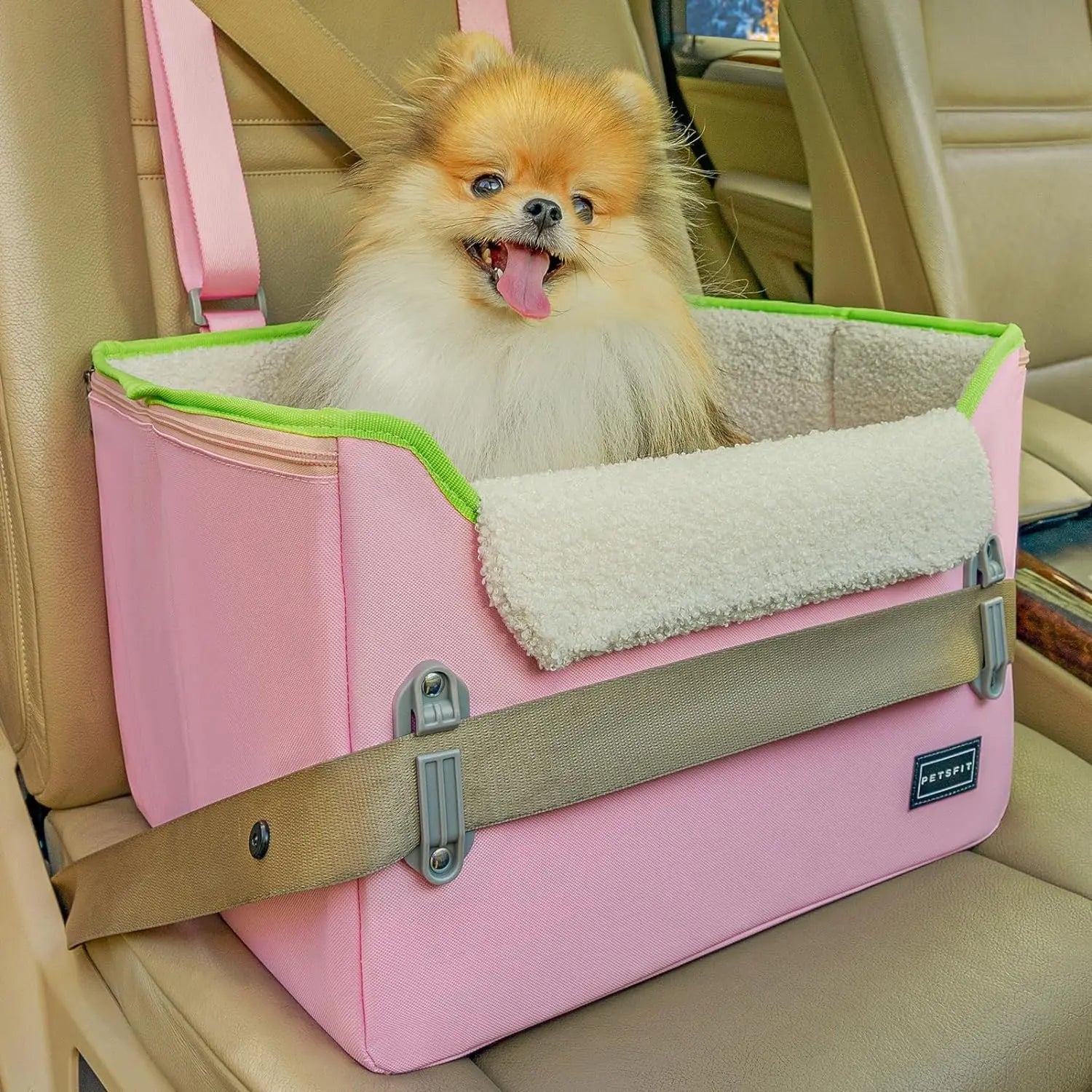 Pink foldable pet booster car seat with green trim, safety buckles, and tether strap