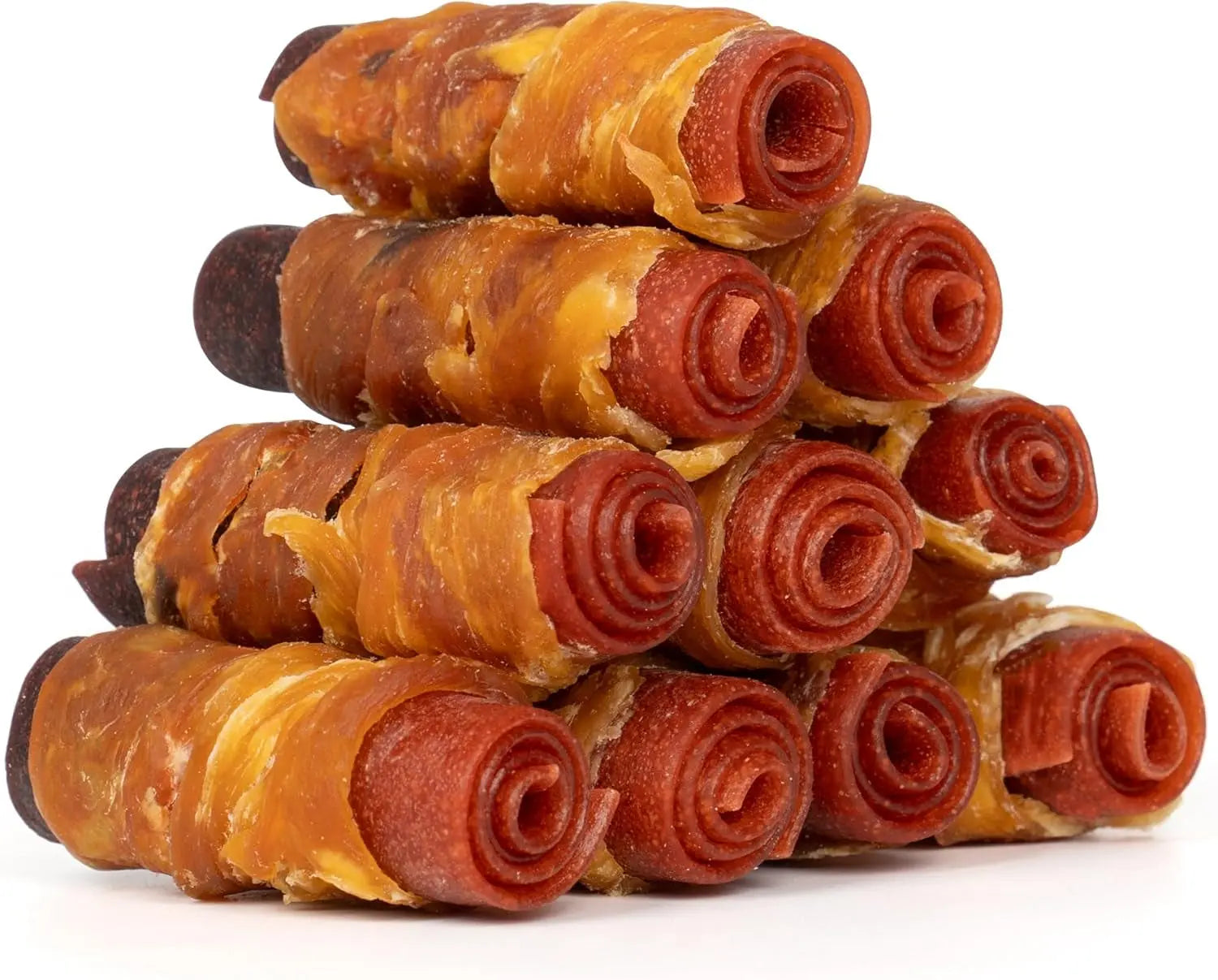 Pile of amber rolled dog treats with red spiral centers