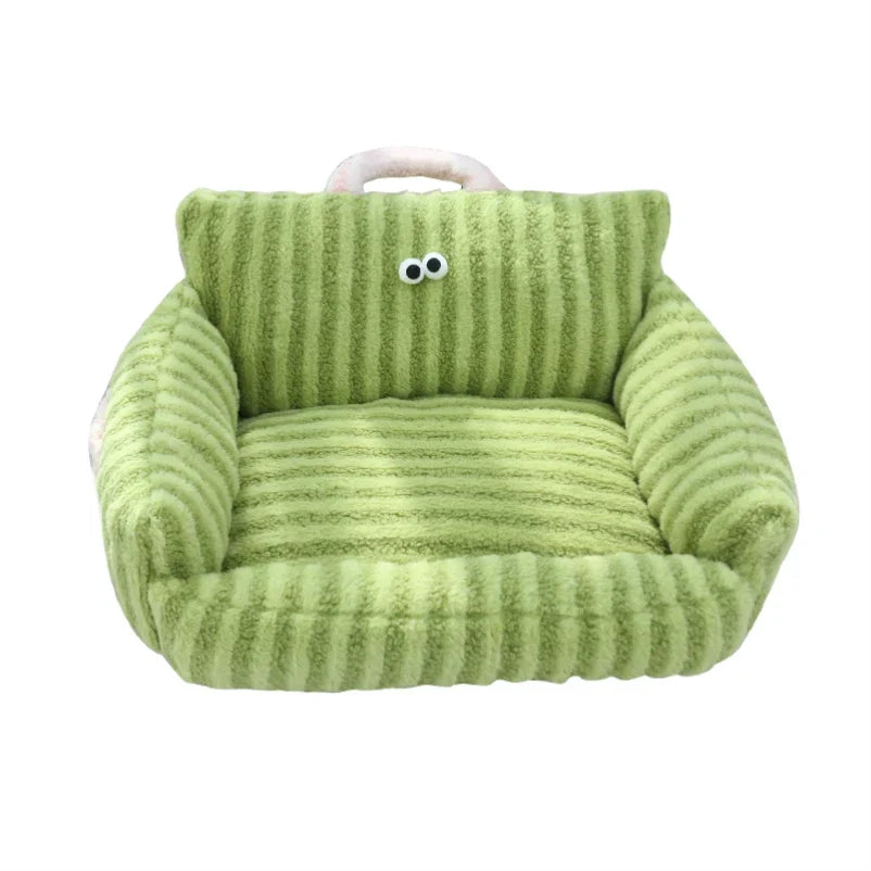 Plush pet sofa bed in green corduroy with cartoon eyes on the backrest