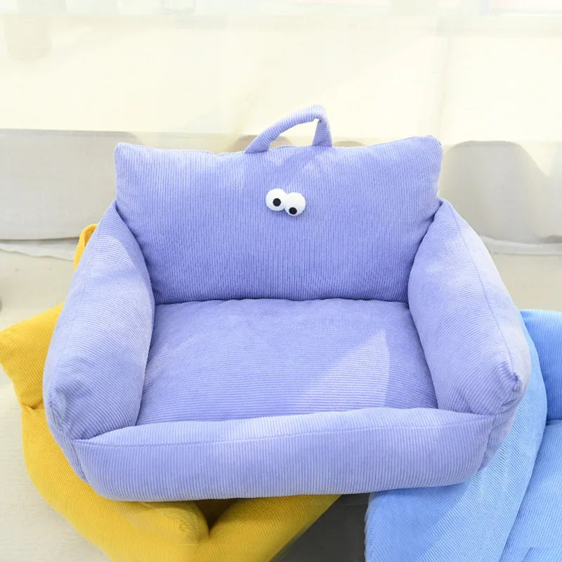 Light blue plush pet sofa bed with handle and cartoon face on the backrest