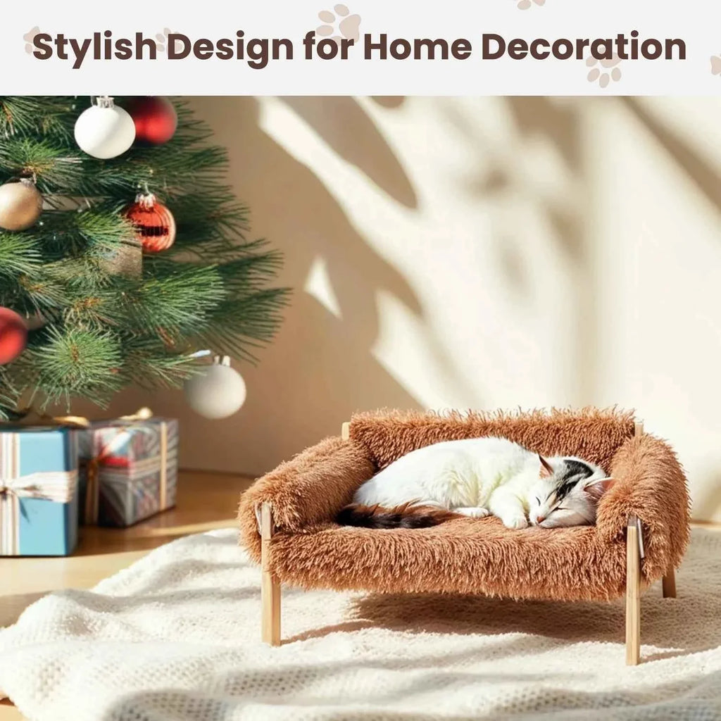 Brown plush raised cat sofa bed with wooden legs; white cat napping on seat