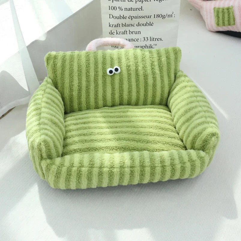 Green plush pet sofa bed with thick striped cushion and cartoon face