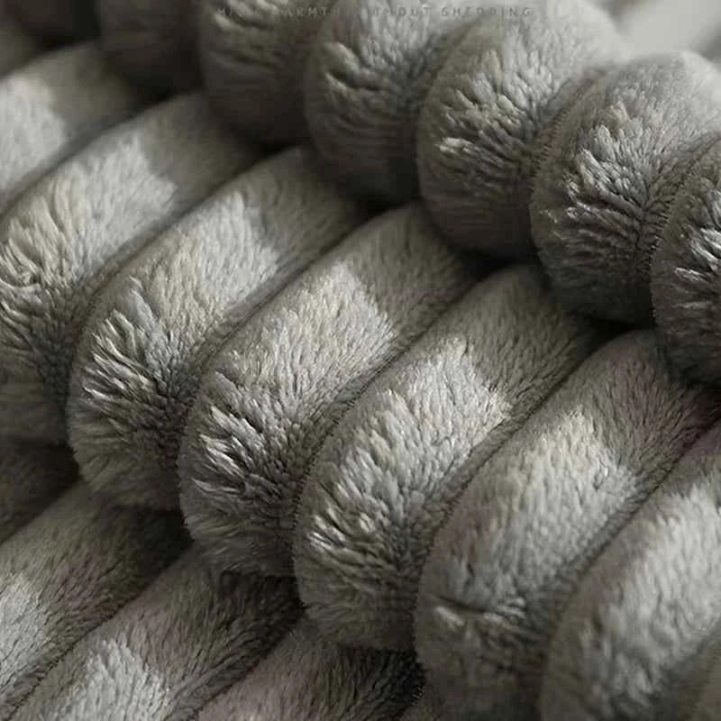 Close-up of gray plush fabric surface with textured pattern on dog cooling mat cover