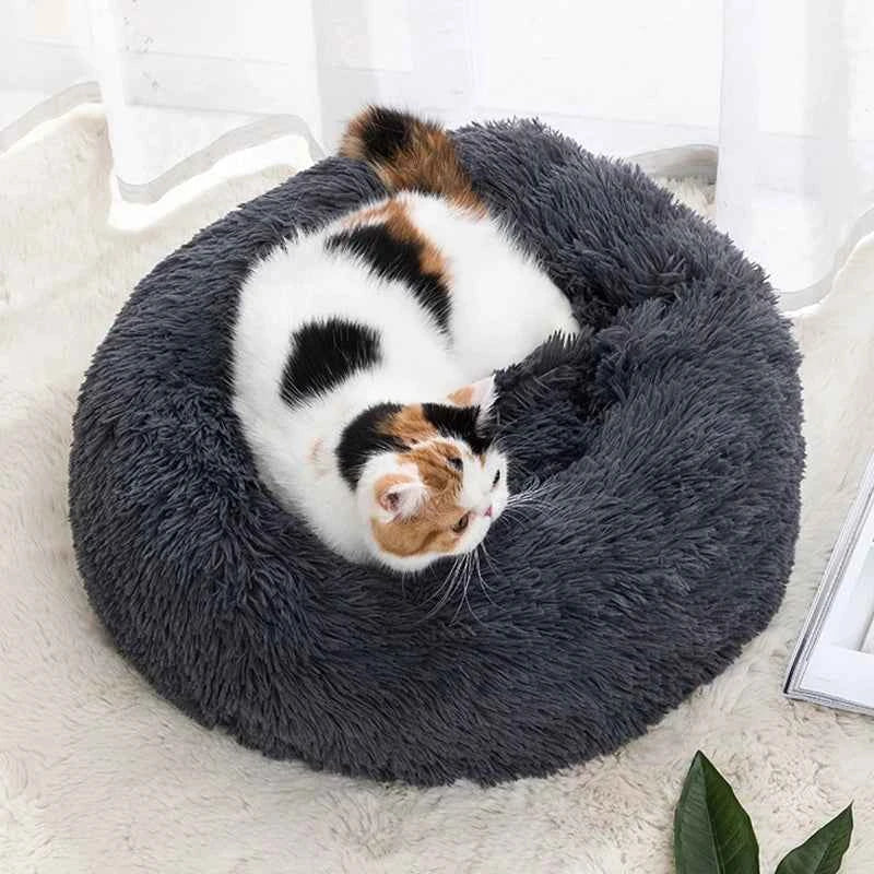 Dark grey round donut pet bed plush nest with cat curled in the center