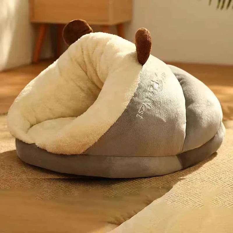 Cream gray slippers-style dog bed with curved front opening and brown ear accents