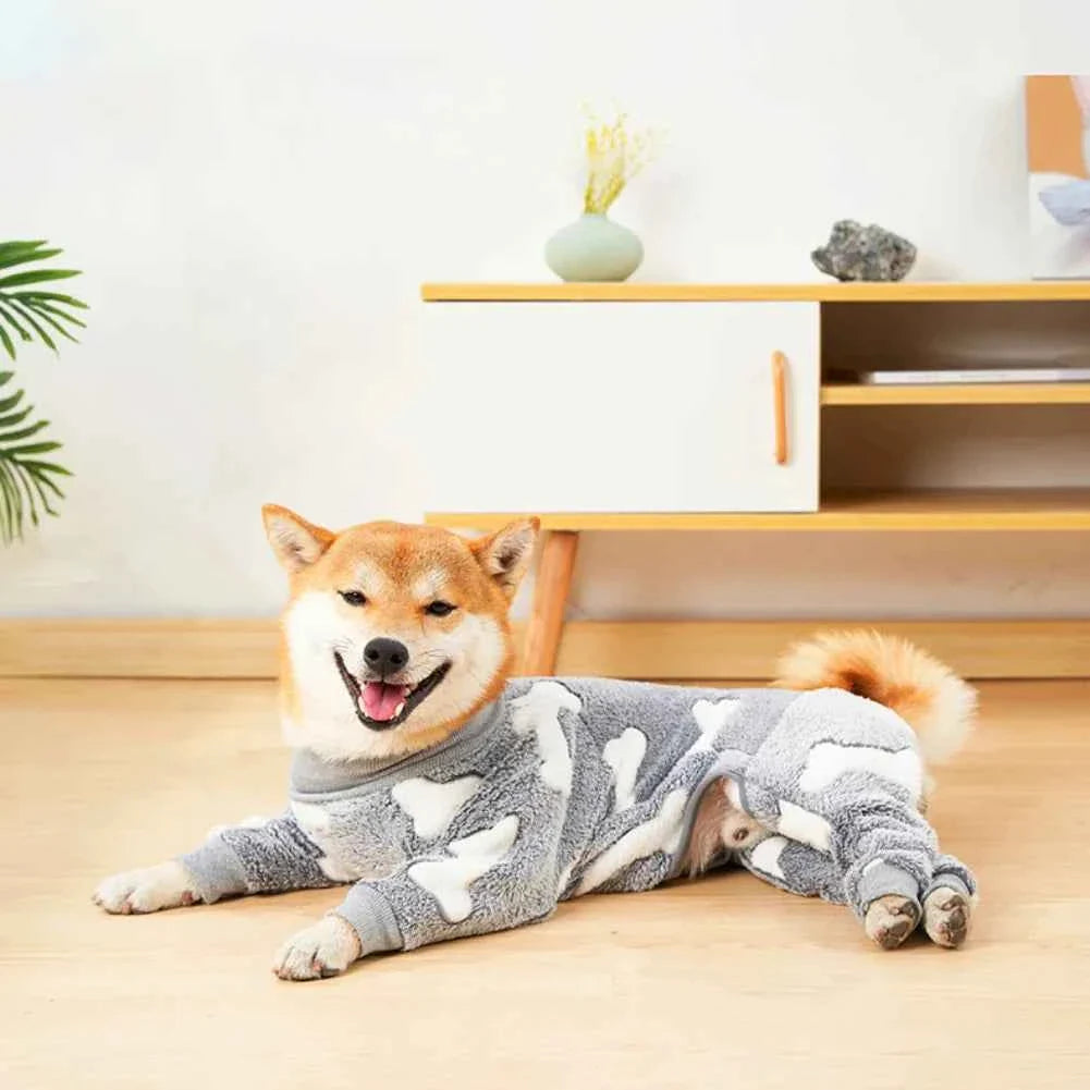 Gray fleece dog jumpsuit pajamas with white bone print, laid down on all fours