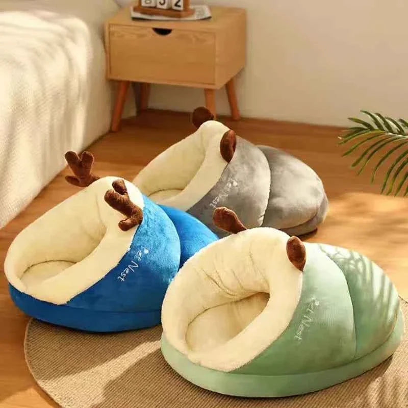 Cozy slippers-style dog beds shown in blue and mint green with plush brown ear handles