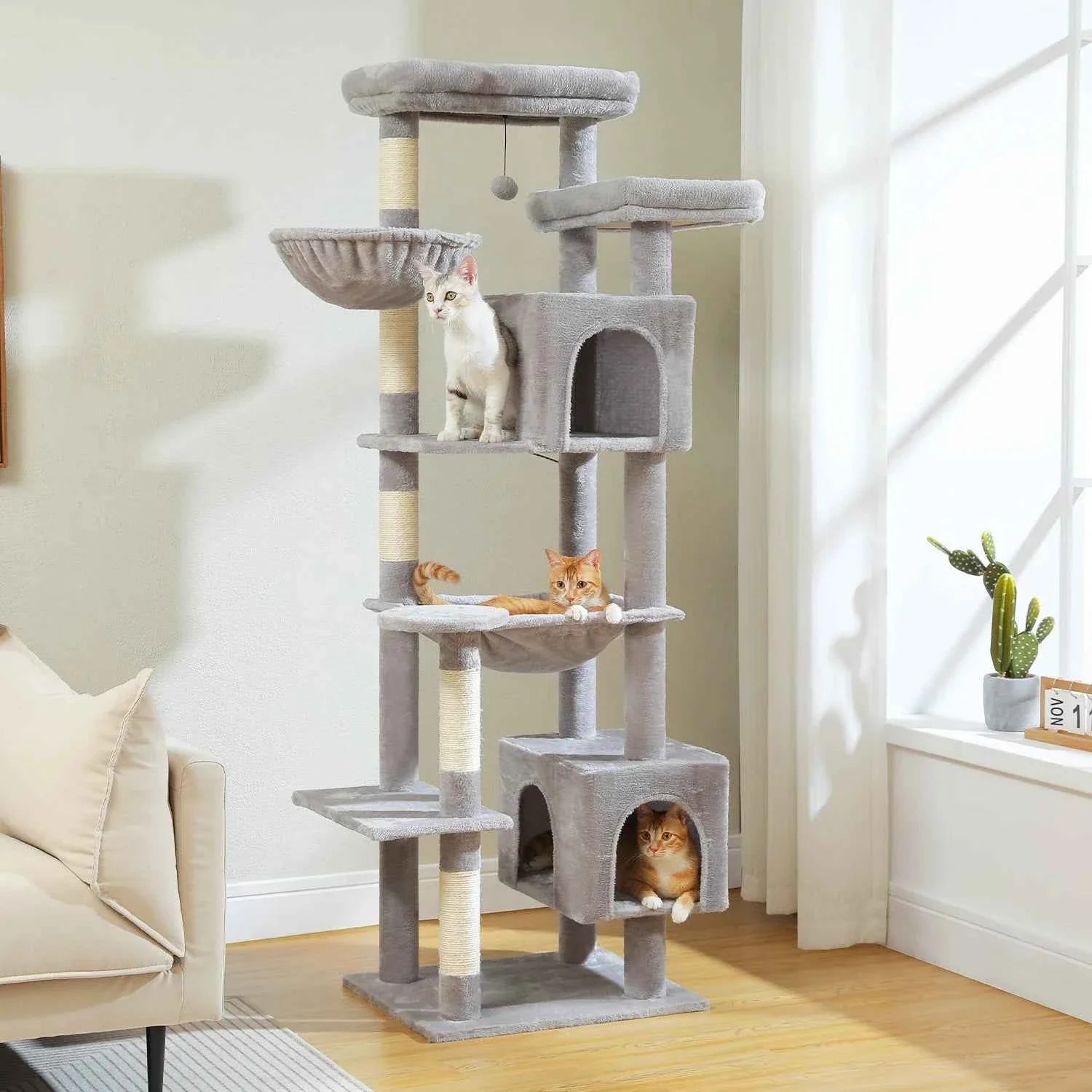 Grey plush cat tree tower with multiple levels, enclosed cubby condos, and scratching posts