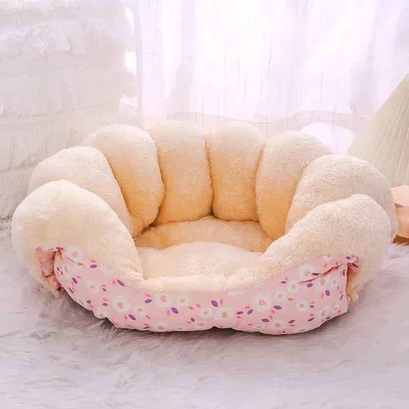 Pink patterned plush oval cat bed with rounded bolsters and open lounging center
