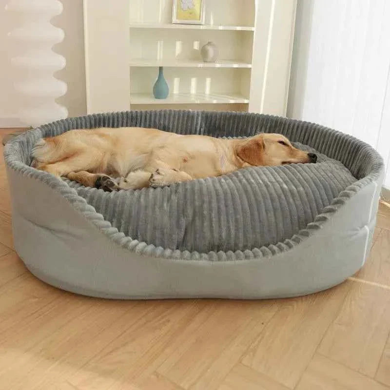 Large round dog bed with ribbed gray center cushion and raised light gray outer bolster