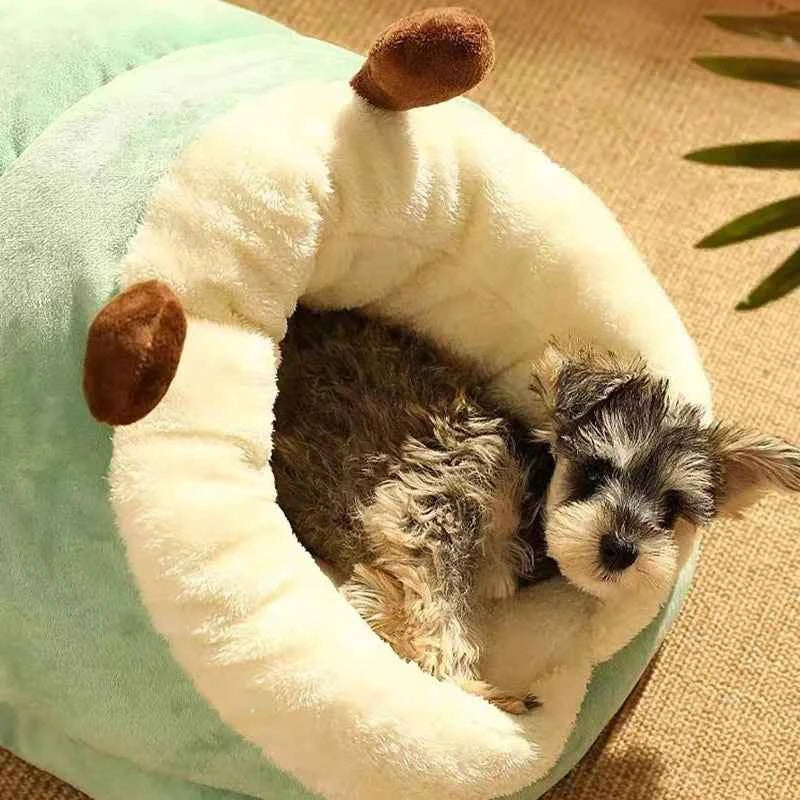 Light green slippers-style dog bed with plush hood and soft, curled dog inside