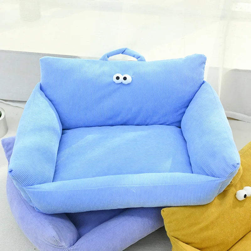 Light blue plush pet sofa bed cushion with curled arms and face patch
