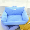 Light blue plush pet sofa bed cushion with curled arms and face patch