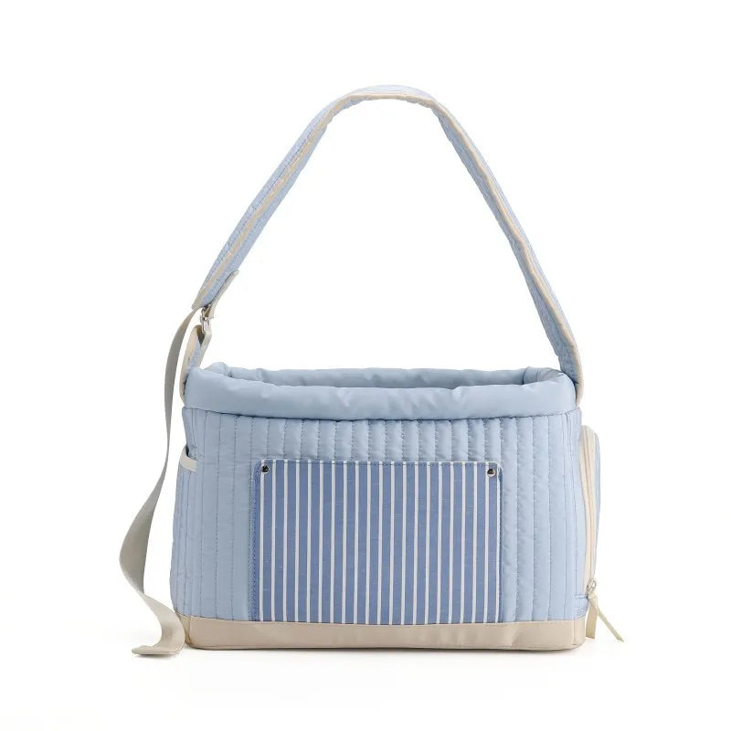 Light blue pet carrier sling bag with quilted hood and blue striped front panel