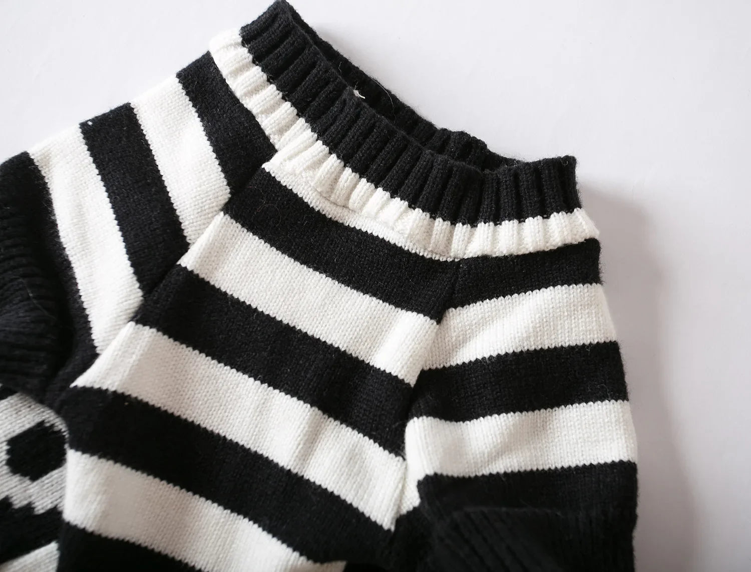 Striped knitted pet sweater in black and white, ribbed turtleneck and cuffs