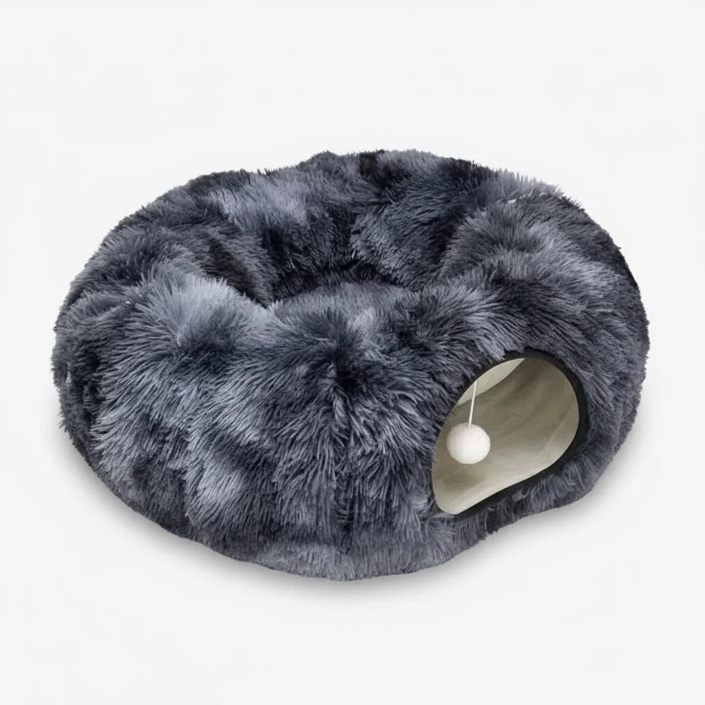 Dark grey plush cat tunnel bed with circular entrance and hanging pom-pom toy