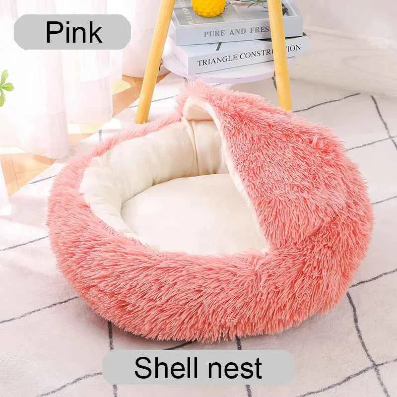 Pink shaggy shell-style donut pet bed with open round center and padded inner cushion