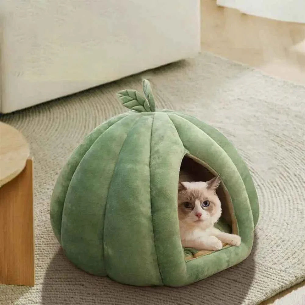 Green pumpkin-shaped pet bed with leaf top and cozy tunnel entrance, cat inside