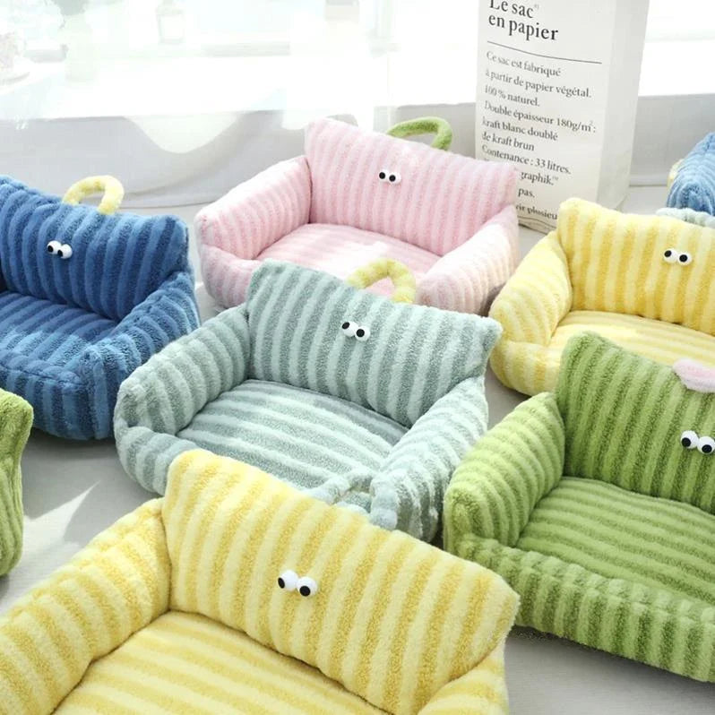 Plush pet sofa beds in blue, pink, green, and yellow corduroy, each with cartoon face
