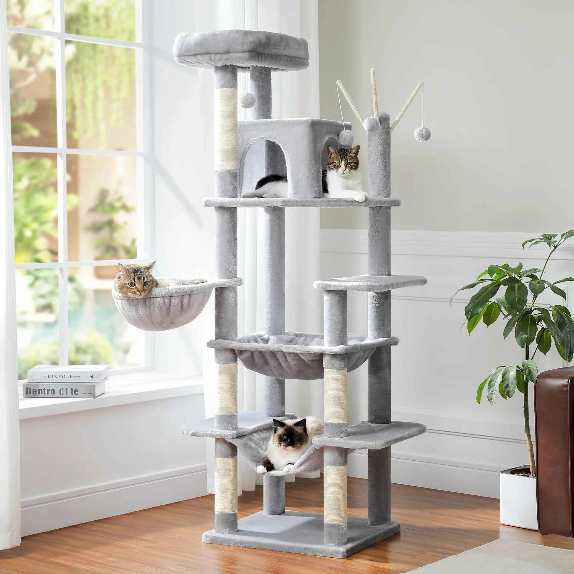 Grey cat tree tower with cushioned perches, loop-hanging toys, and multi-level scratching posts