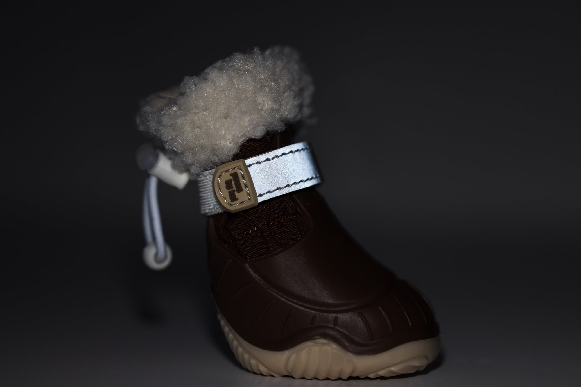 Brown dog snow boot with faux-fur cuff and side buckle strap on cushioned sole