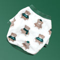 Folded fleece dog pajamas in white with brown bear prints and green cuffs