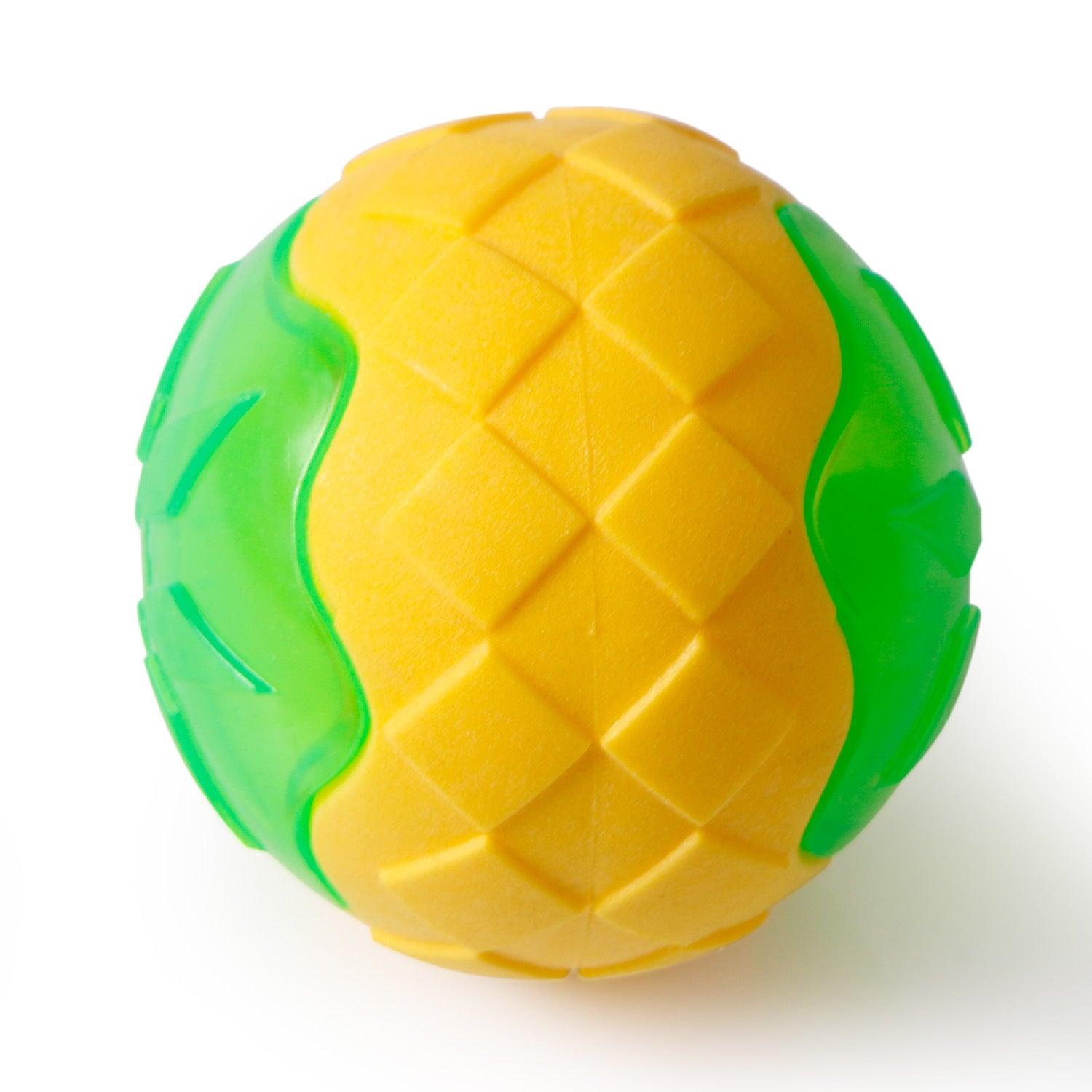 Close-up of glowing audible dog toy ball in yellow with green textured edges