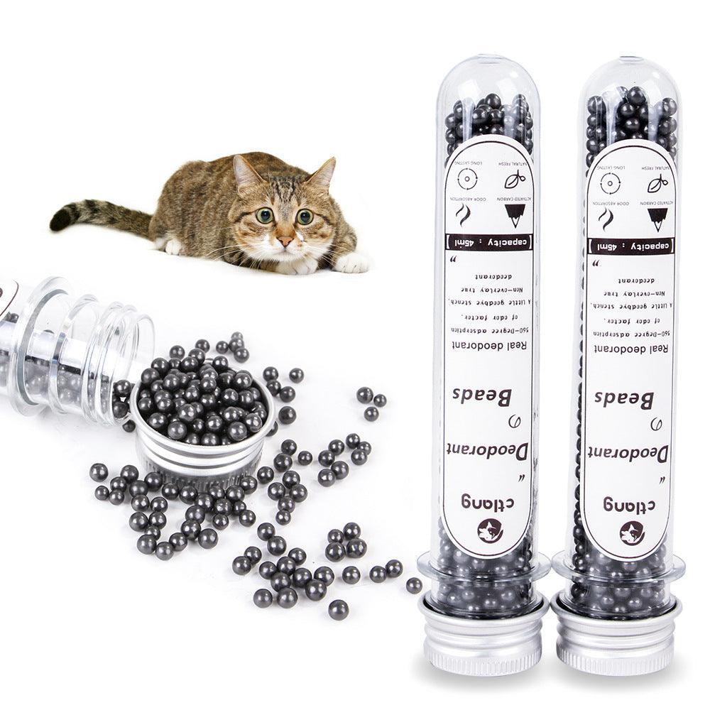 Two cat litter deodorizer vials with black activated carbon beads and scattered beads