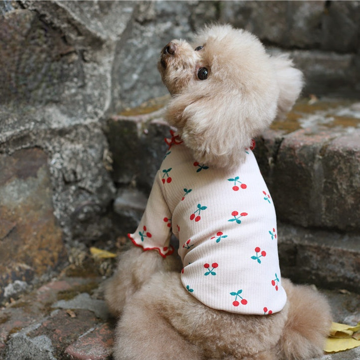 Dog top white with cherry print and red trim, lapels and wavy hem