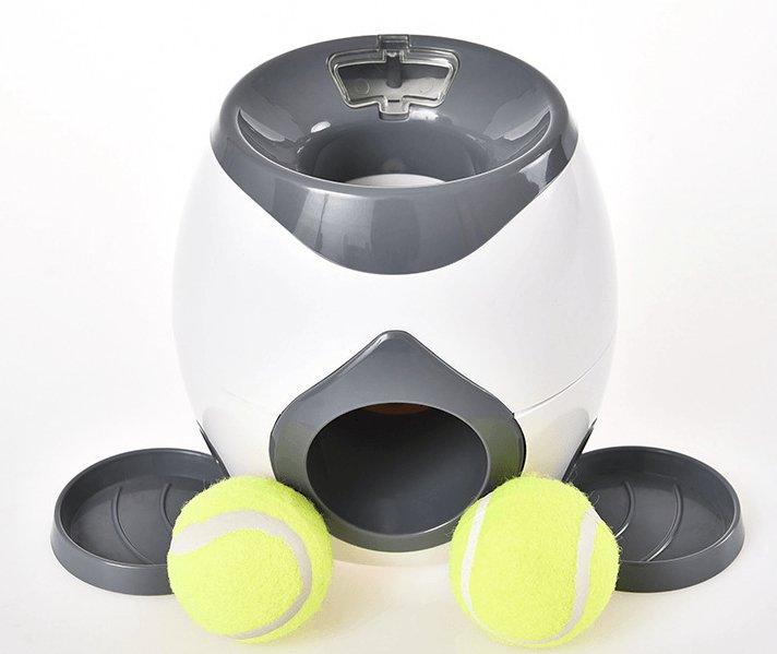 Automatic pet feeder with dark gray top bowl, side chute, and two yellow tennis balls