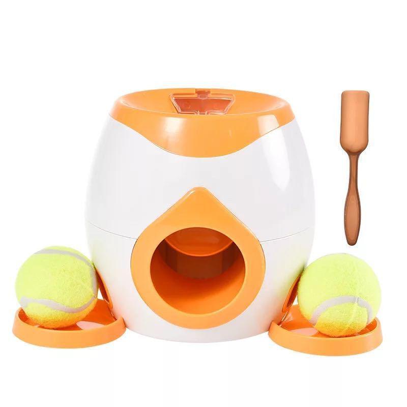 Automatic pet feeder in white and orange with tennis balls, side openings, and orange mat