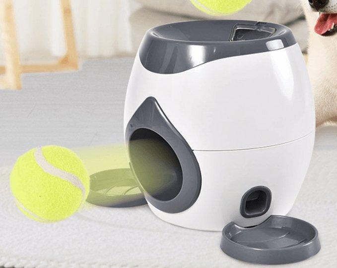 Automatic pet feeder with side chute and yellow tennis ball; gray base tray shown