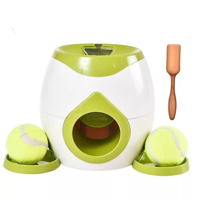 Automatic pet feeder in white and green with tennis balls, side openings, and green mat