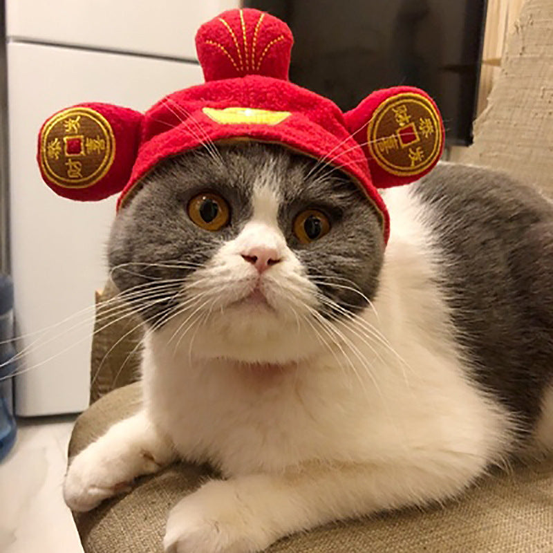 Red plush pet hat with gold circular emblems and small yellow center detail